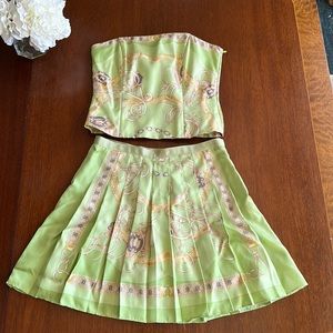 Green w equestrian detail. Strapless top w pleated mini skirt.